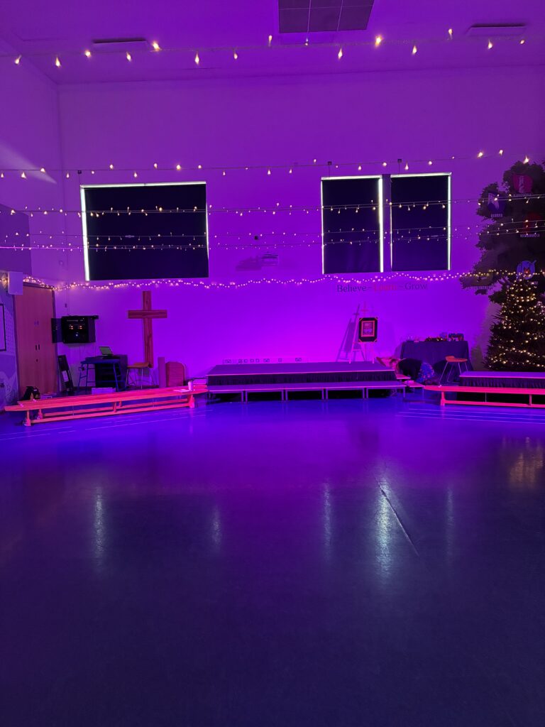 Purple wash lighting in the hall at Ridgeway Farm C of E Primary School